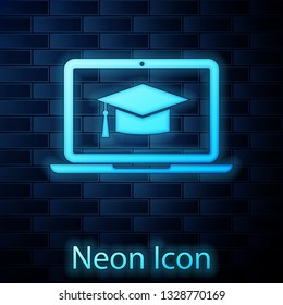Glowing neon Graduation cap on screen laptop icon isolated on brick wall background. Online learning or e-learning concept. Vector Illustration
