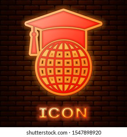Glowing neon Graduation cap on globe icon isolated on brick wall background. World education symbol. Online learning or e-learning concept.  Vector Illustration