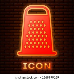 Glowing neon Grater icon isolated on brick wall background. Kitchen symbol. Cooking utensil. Cutlery sign.  Vector Illustration