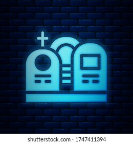 Glowing neon Grave with tombstone icon isolated on brick wall background.  Vector