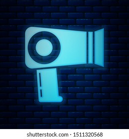 Glowing neon Hair dryer icon isolated on brick wall background. Hairdryer sign. Hair drying symbol. Blowing hot air.  Vector Illustration
