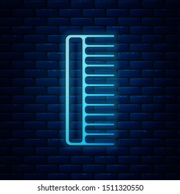 Glowing neon Hairbrush icon isolated on brick wall background. Comb hair sign. Barber symbol.  Vector Illustration