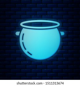 Glowing neon Halloween witch cauldron icon isolated on brick wall background. Happy Halloween party.  Vector Illustration
