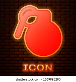 Glowing neon Hand grenade icon isolated on brick wall background. Bomb explosion.  Vector Illustration