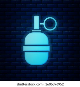 Glowing neon Hand grenade icon isolated on brick wall background. Bomb explosion.  Vector Illustration
