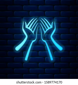Glowing neon Hands icon isolated on brick wall background.  Vector Illustration
