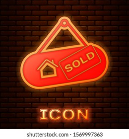 Glowing neon Hanging sign with text Sold icon isolated on brick wall background. Sold sticker. Sold signboard.  Vector Illustration