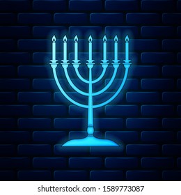 Glowing neon Hanukkah menorah icon isolated on brick wall background. Religion icon. Hanukkah traditional symbol. Holiday religion, jewish festival of Lights.  Vector Illustration