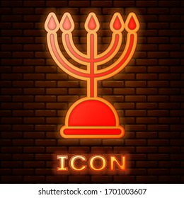 Glowing neon Hanukkah menorah icon isolated on brick wall background. Hanukkah traditional symbol. Holiday religion, jewish festival of Lights. Vector Illustration