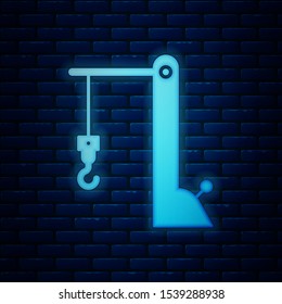 Glowing neon Harbor port crane icon isolated on brick wall background. Cargo crane tower.  Vector Illustration