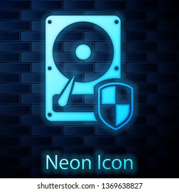 Glowing neon Hard disk drive (HDD) protection icon isolated on brick wall background. Vector Illustration