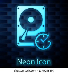 Glowing neon Hard disk drive with clockwise sign, data recovery icon isolated on brick wall background. Vector Illustration