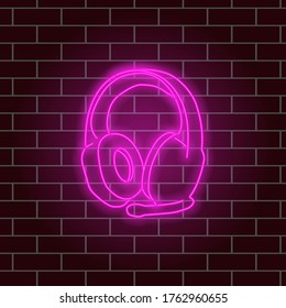 Glowing neon headphones. Pink color. Vector illustration.