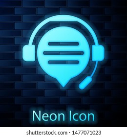 Glowing neon Headphones with speech bubble chat icon isolated on brick wall background. Support customer service, hotline, call center, faq, maintenance.  Vector Illustration