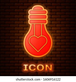Glowing neon Heart shape in a light bulb icon isolated on brick wall background. Love symbol. Valentine day symbol.  Vector Illustration