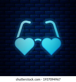 Glowing neon Heart shaped love glasses icon isolated on brick wall background. Suitable for Valentine day card design.  Vector