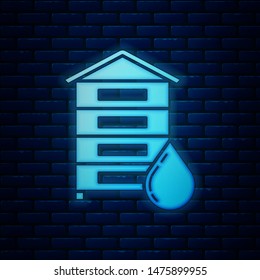 Glowing neon Hive for bees icon isolated on brick wall background. Beehive symbol. Apiary and beekeeping. Sweet natural food.  Vector Illustration