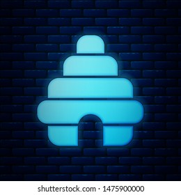 Glowing neon Hive for bees icon isolated on brick wall background. Beehive symbol. Apiary and beekeeping. Sweet natural food.  Vector Illustration