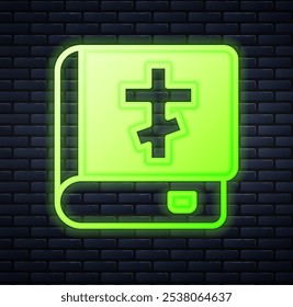 Glowing neon Holy bible book icon isolated on brick wall background.  Vector