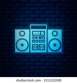 Glowing neon Home stereo with two speakers icon isolated on brick wall background. Music system.  Vector Illustration