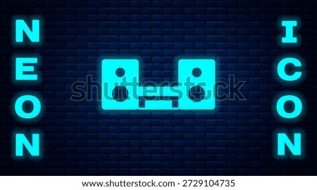 Glowing neon Home stereo with two speakers icon isolated on brick wall background. Music system.  Vector
