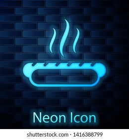Glowing neon Hotdog sandwich with mustard icon isolated on brick wall background. Sausage icon. Fast food sign. Vector Illustration