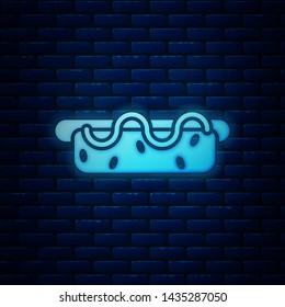 Glowing neon Hotdog sandwich with mustard icon isolated on brick wall background. Sausage icon. Street fast food menu.  Vector Illustration
