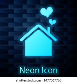 Glowing neon House with heart shape icon isolated on brick wall background. Love home symbol. Family, real estate and realty.  Vector Illustration
