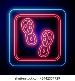 Glowing neon Human footprints shoes icon isolated on black background. Shoes sole.  Vector