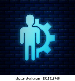 Glowing neon Human with gear inside icon isolated on brick wall background. Artificial intelligence. Thinking brain sign. Symbol work of brain.  Vector Illustration