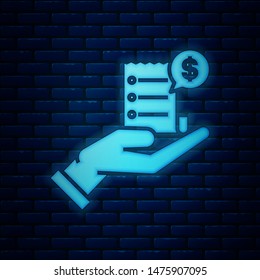 Glowing neon Human hand holding with blank receipt or bill for payment icon isolated on brick wall background. Banking and business operations.  Vector Illustration