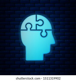 Glowing neon Human head puzzles strategy icon isolated on brick wall background. Thinking brain sign. Symbol work of brain.  Vector Illustration