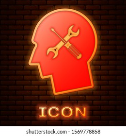 Glowing neon Human head with with screwdriver and wrench icon isolated on brick wall background. Artificial intelligence. Symbol work of brain.  Vector Illustration