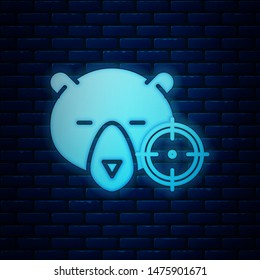 Glowing neon Hunt on bear with crosshairs icon isolated on brick wall background. Hunting club logo with bear and target. Rifle lens aiming a bear.  Vector Illustration