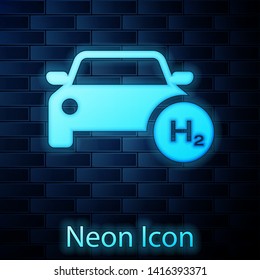 Glowing neon Hydrogen car icon isolated on brick wall background. H2 station sign. Hydrogen fuel cell car eco environment friendly zero emission. Vector Illustration