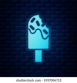Glowing neon Ice cream icon isolated on brick wall background. Sweet symbol.  Vector