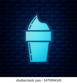 Glowing neon Ice cream in waffle cone icon isolated on brick wall background. Sweet symbol.  Vector Illustration