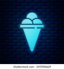 Glowing neon Ice cream in waffle cone icon isolated on brick wall background. Sweet symbol.  Vector