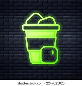 Glowing neon Iced coffee icon isolated on brick wall background.  Vector
