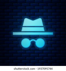 Glowing neon Incognito mode icon isolated on brick wall background.  Vector