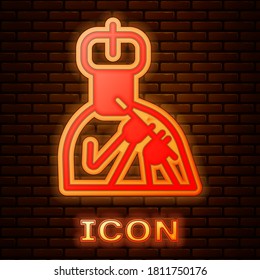 Glowing neon Indian man plays flute icon isolated on brick wall background. Artist playing Bansuri folk music of India. Vector.