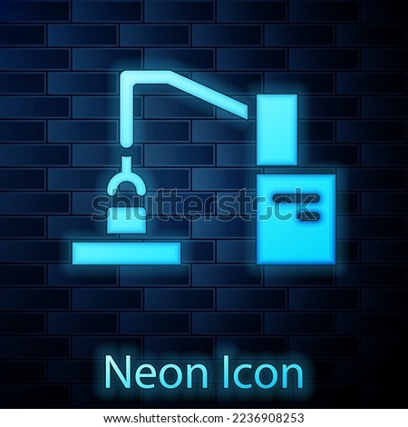 Glowing neon Industrial machine robotic robot arm hand factory icon isolated on brick wall background. Industrial robot manipulator.  Vector
