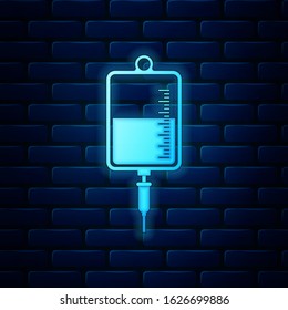 Glowing neon IV bag icon isolated on brick wall background. Blood bag icon. Donate blood concept. The concept of treatment and therapy, chemotherapy.  Vector Illustration