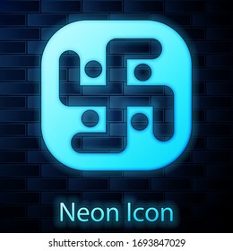 Glowing neon Jainism icon isolated on brick wall background. Vector Illustration