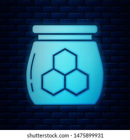 Glowing neon Jar of honey icon isolated on brick wall background. Food bank. Sweet natural food symbol.  Vector Illustration