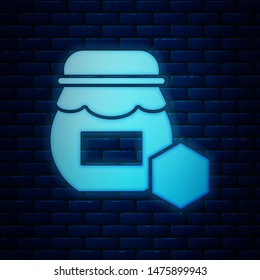 Glowing neon Jar of honey icon isolated on brick wall background. Food bank. Sweet natural food symbol.  Vector Illustration