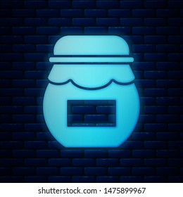 Glowing neon Jar of honey icon isolated on brick wall background. Food bank. Sweet natural food symbol.  Vector Illustration