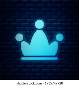 Glowing neon Jester hat with bells isolated on brick wall background. Clown icon. Amusement park funnyman sign.  Vector