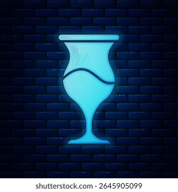 Glowing neon Jewish goblet icon isolated on brick wall background. Jewish wine cup for kiddush. Kiddush cup for Shabbat.  Vector
