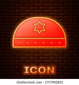 Glowing neon Jewish kippah with star of david icon isolated on brick wall background. Jewish yarmulke hat. Vector Illustration